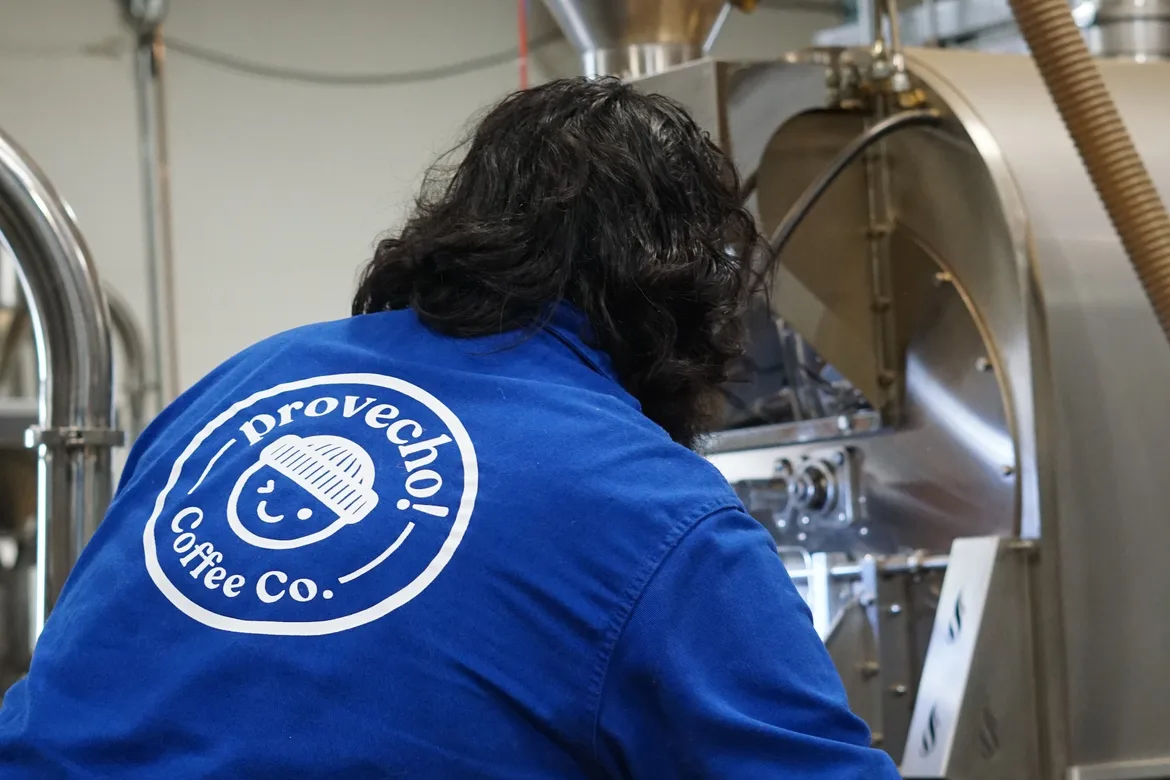 A roaster working the controls of the Loring roasting machine