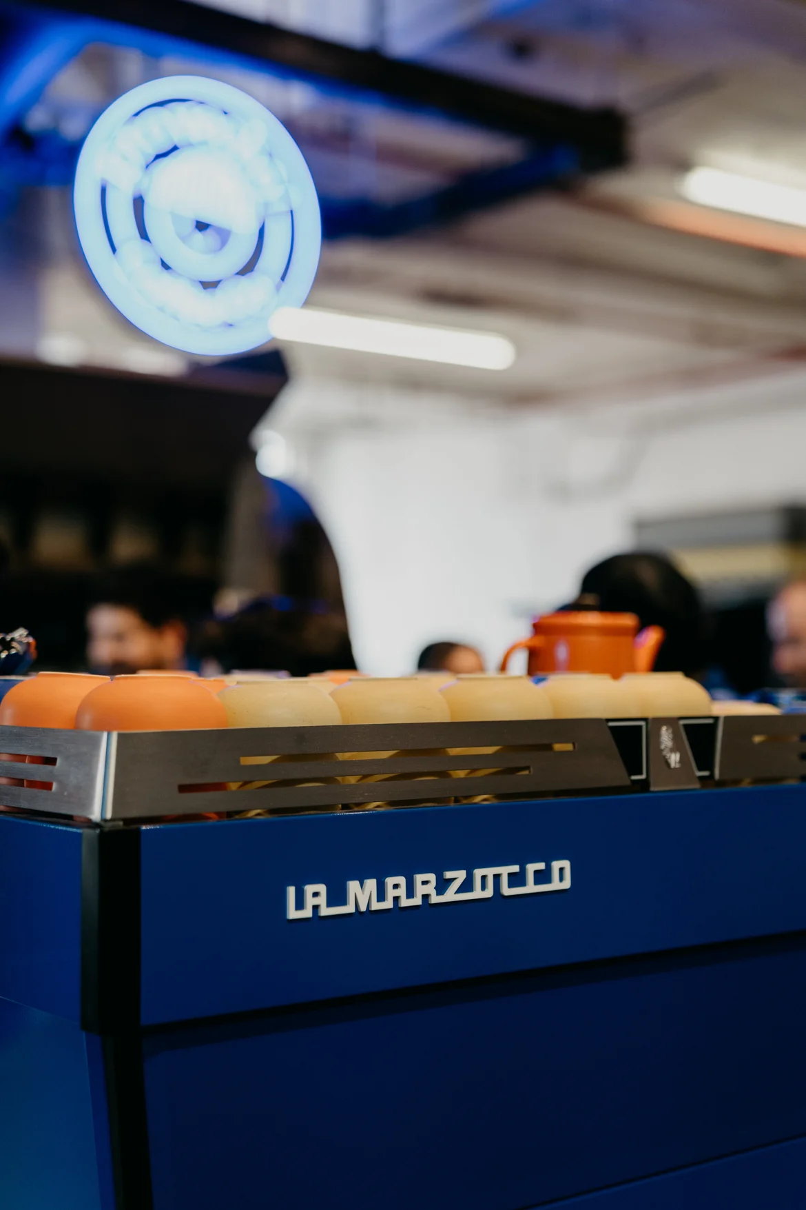 The blue La Marzocco espresso machine on the bar