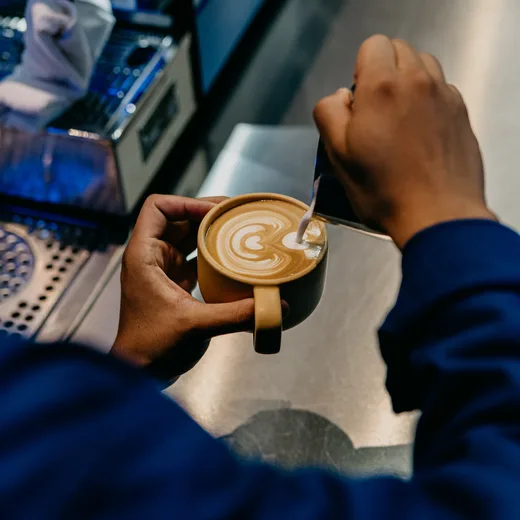 Latte art being poured into a cup, seen from above