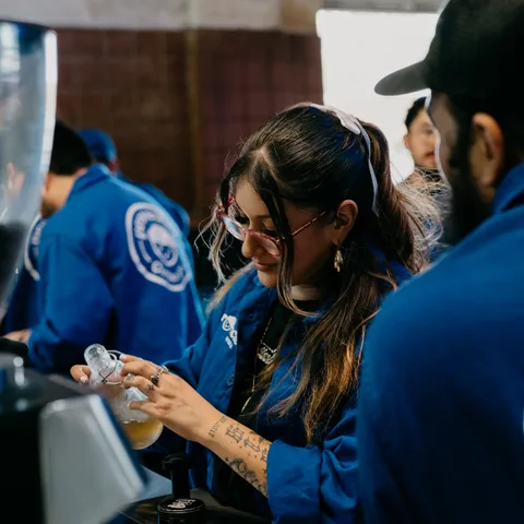 Two baristas working the espresso bar together