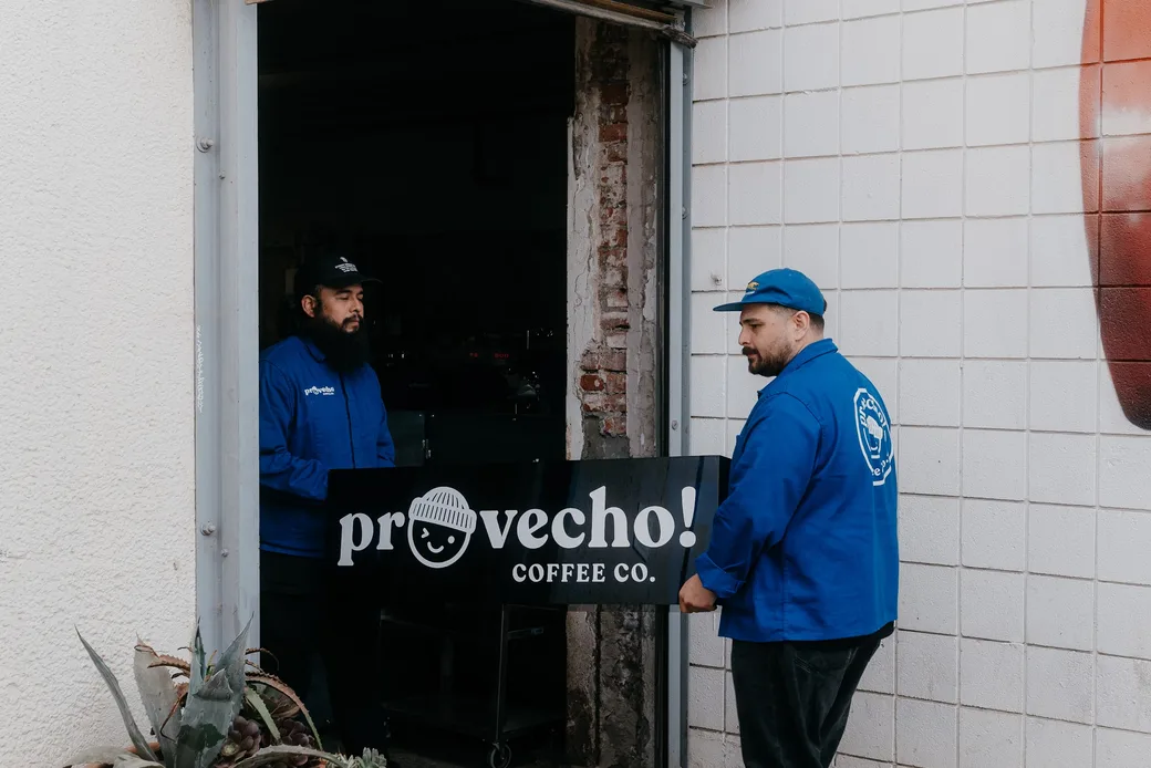 The Provecho entrance from the street, sign above the door